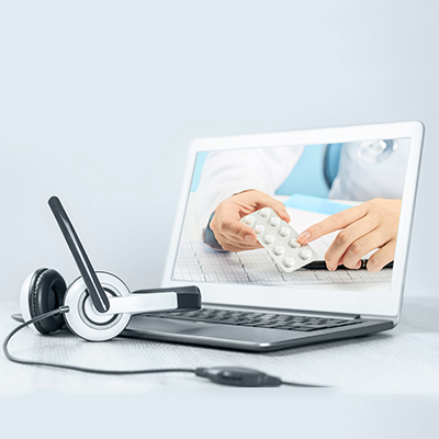 Doctor and patient teleconsulting via laptop. headphones nearby