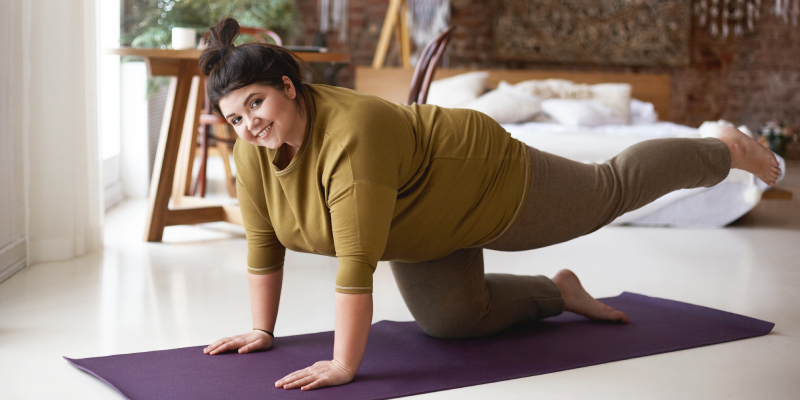 A young woman is doing yoga exercises for weight loss.