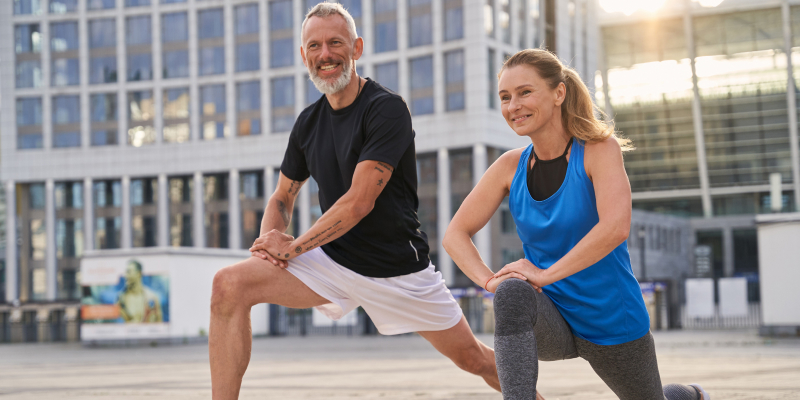 A health-conscious middle-aged couple engaged in their regular fitness routine.